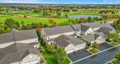 an aerial view of a house with garden space and street view