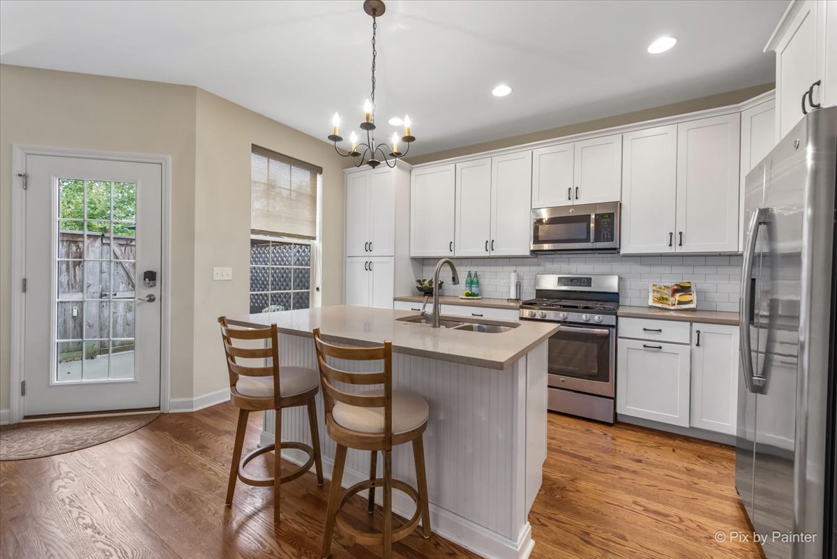 2122 Shermer Road Glenview, IL 60026 - Photo 4 of 37 a kitchen with stainless steel appliances granite countertop a stove a sink dishwasher a refrigerator with a dining table and chairs