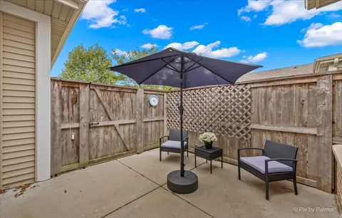 a patio with barbeque grill and outdoor seating
