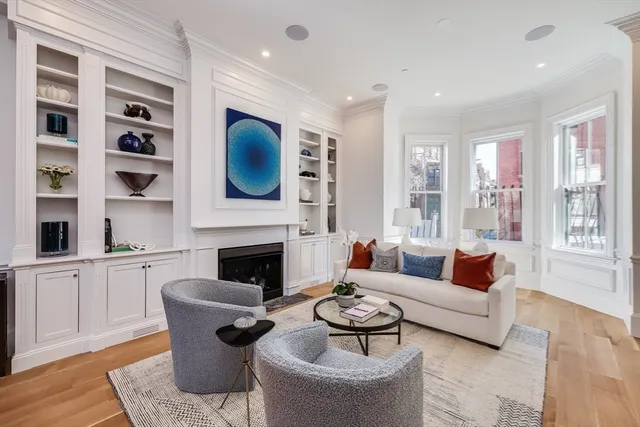 a living room with furniture fireplace and window