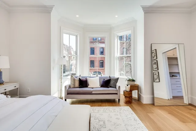 a spacious bedroom with a large bed and a couch