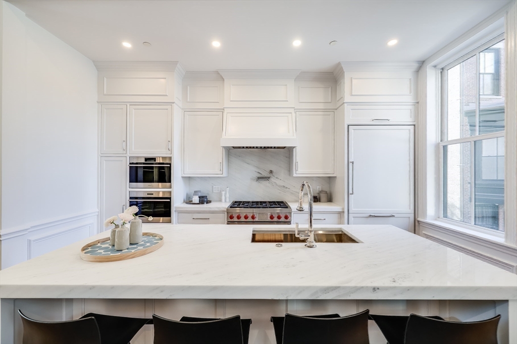 1 Fairfield Street Boston, MA 02116 - Photo 22 of 28 a kitchen with kitchen island stainless steel appliances a sink and a stove