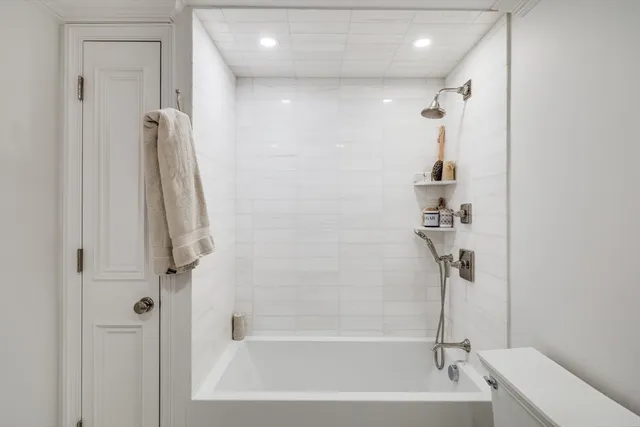 a bathroom with a shower and a bath tub