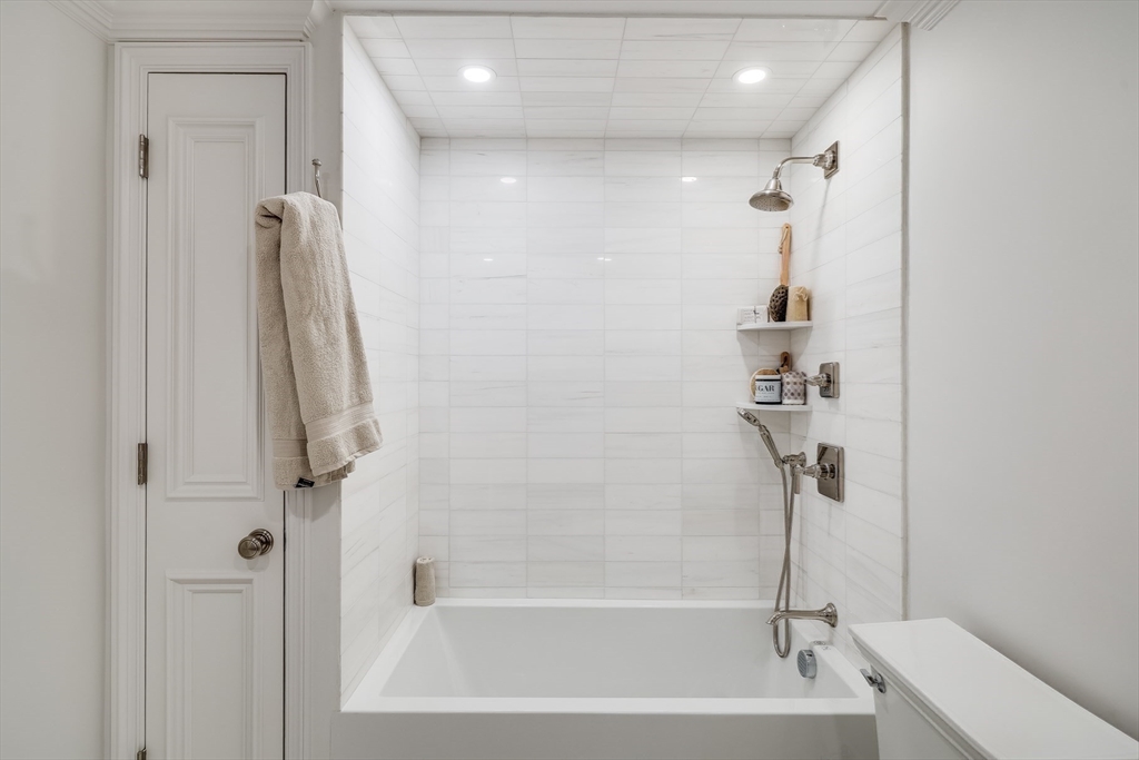 1 Fairfield Street Boston, MA 02116 - Photo 27 of 28 a bathroom with a shower and a bath tub