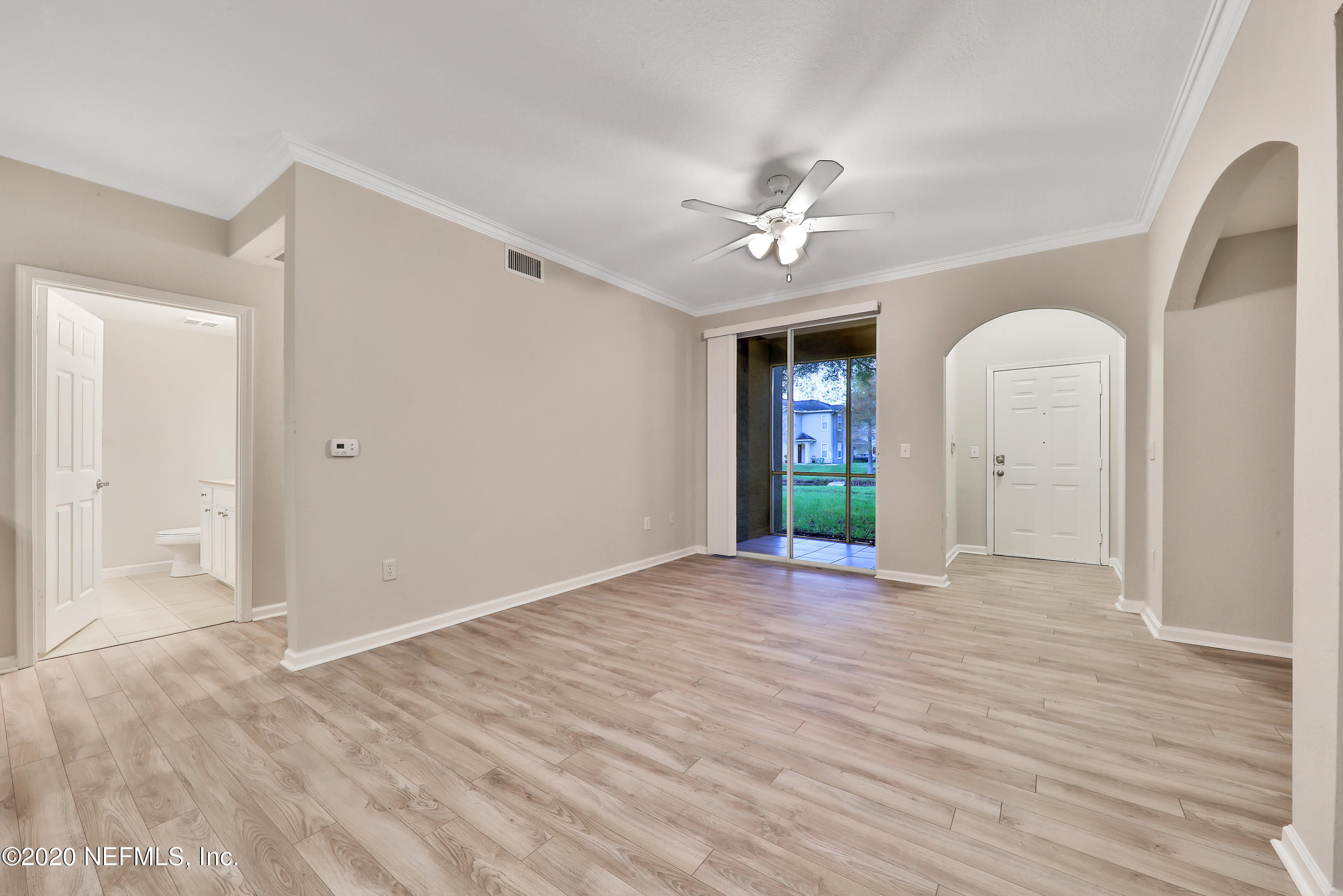 10075 Gate Parkway, Unit 1009 Jacksonville, FL 32246 - Photo 11 of 51 a view of an empty room with window and wooden floor
