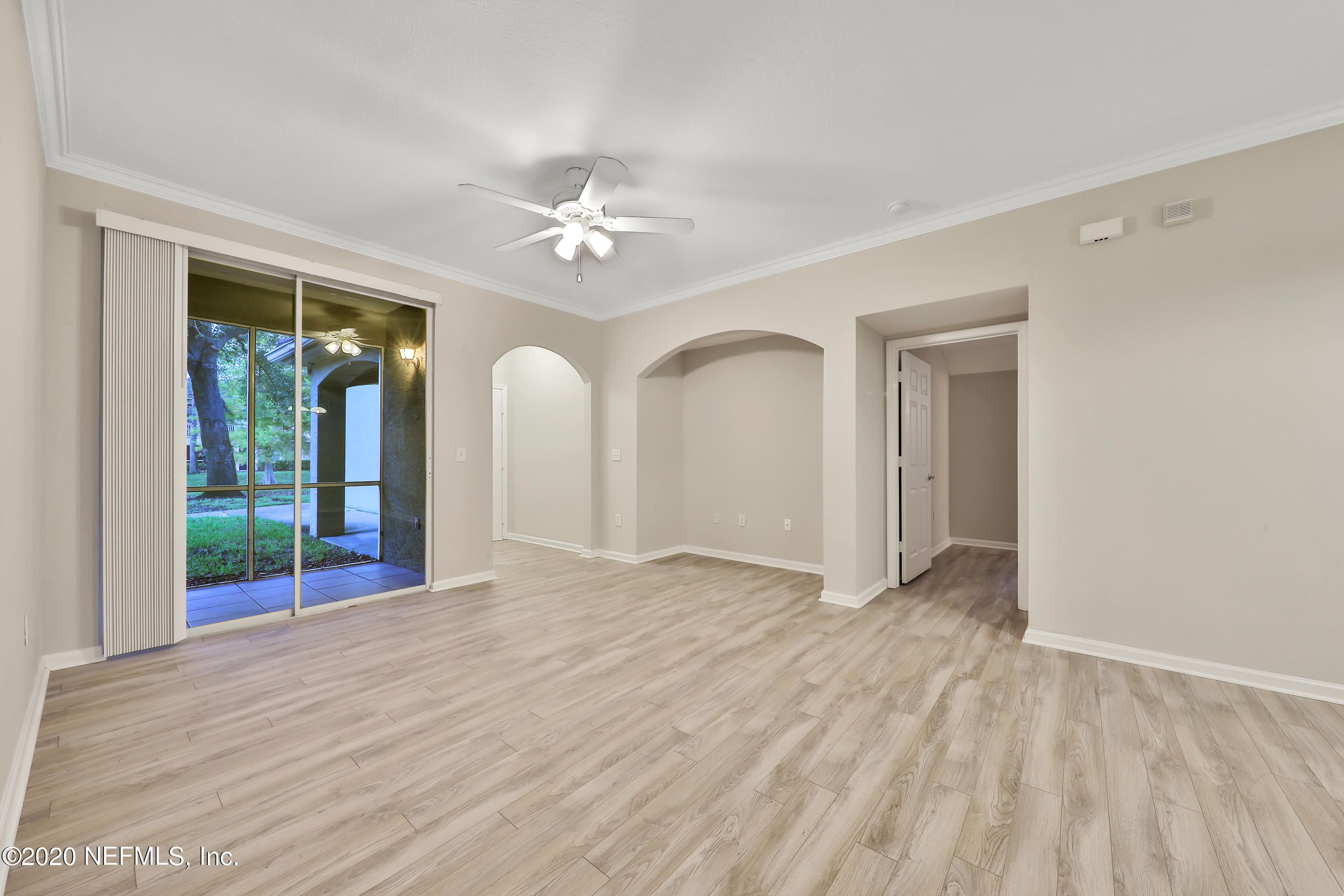 10075 Gate Parkway, Unit 1009 Jacksonville, FL 32246 - Photo 13 of 51 a view of empty room with wooden floor and fan
