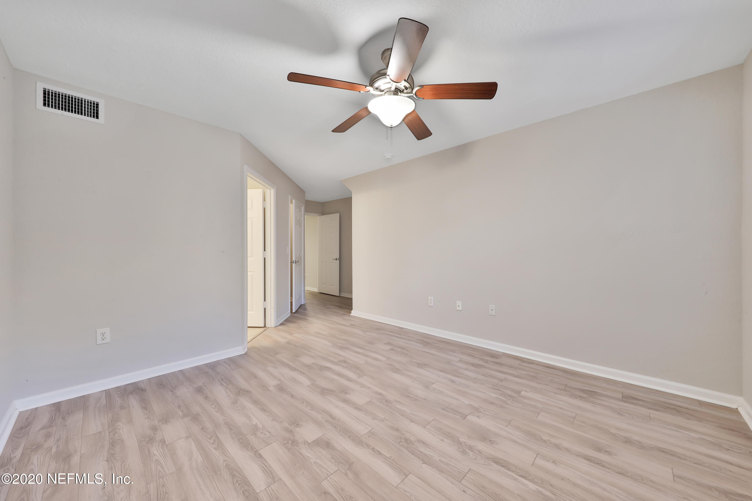 10075 Gate Parkway, Unit 1009 Jacksonville, FL 32246 - Photo 14 of 51 a view of an empty room with wooden floor