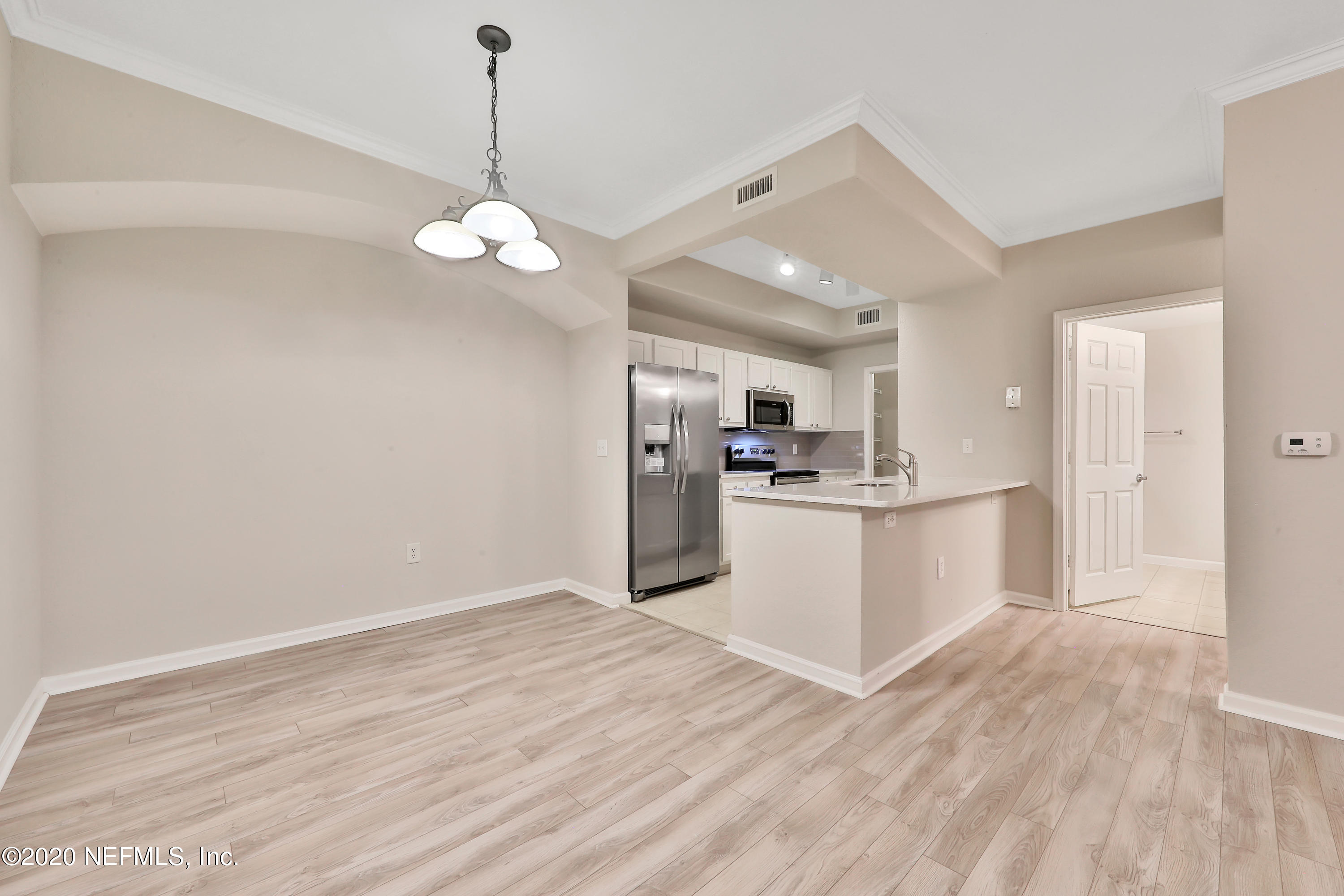 10075 Gate Parkway, Unit 1009 Jacksonville, FL 32246 - Photo 20 of 51 a view of kitchen with refrigerator and wooden floor