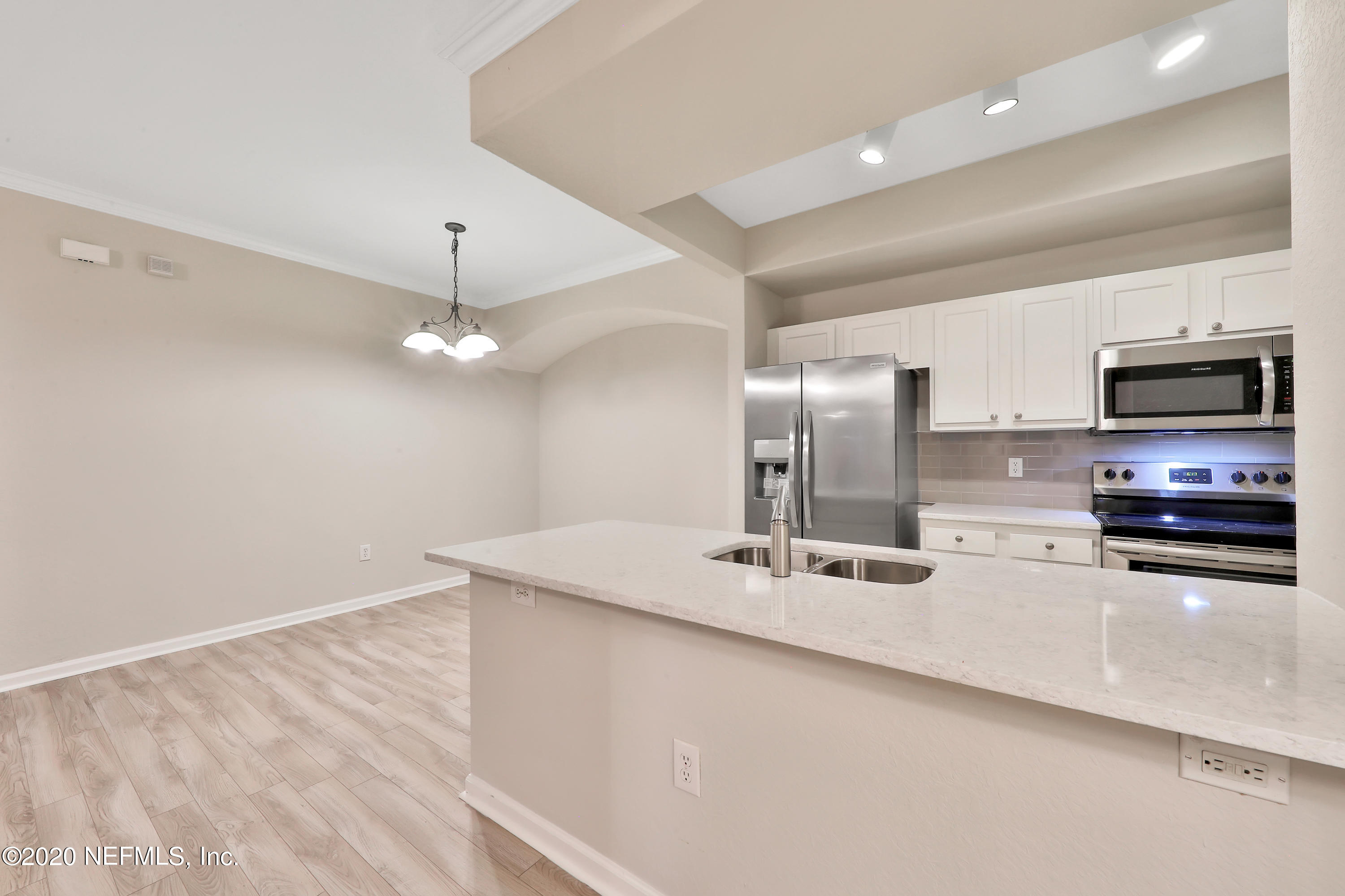 10075 Gate Parkway, Unit 1009 Jacksonville, FL 32246 - Photo 2 of 51 a kitchen with stainless steel appliances a refrigerator sink and microwave