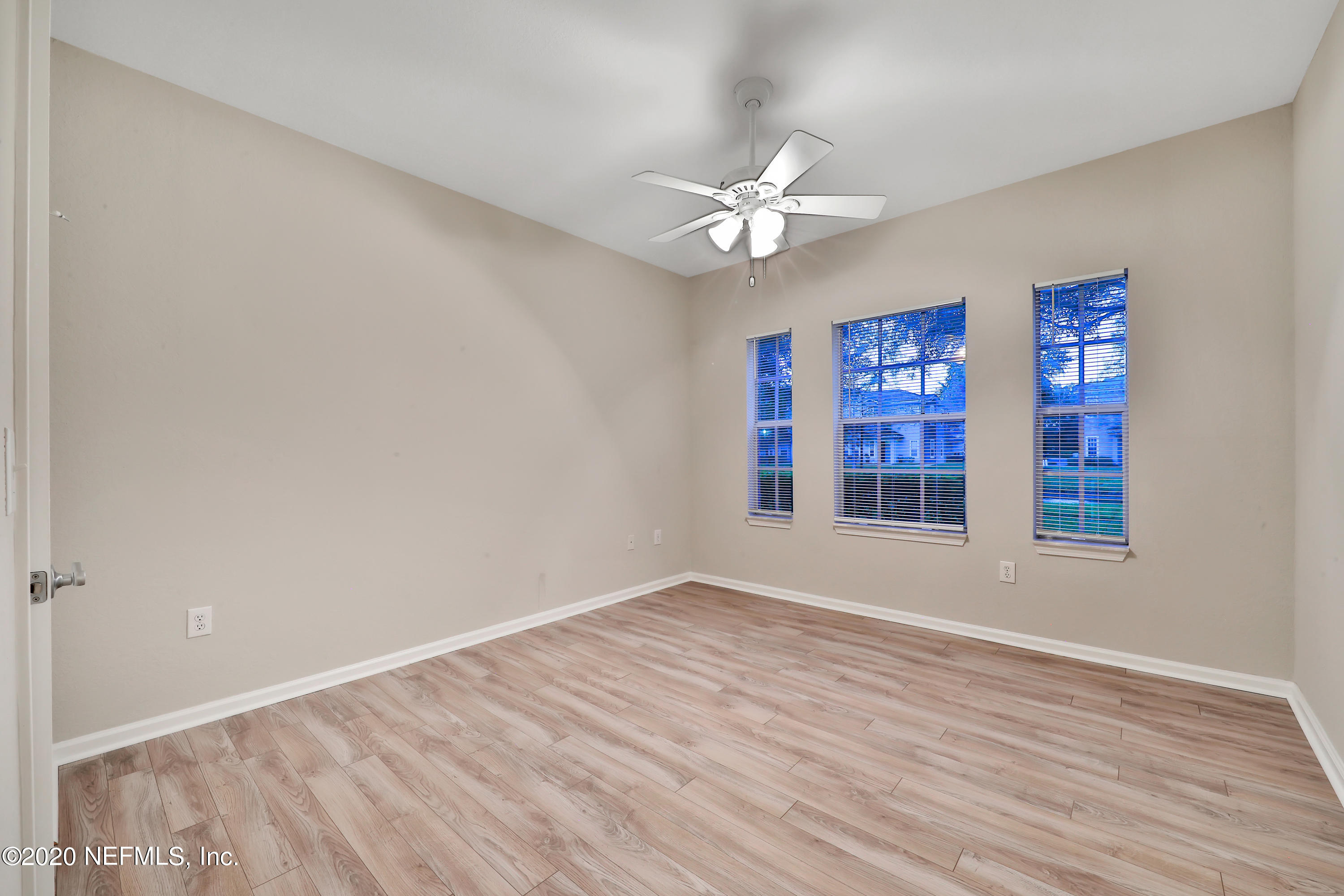 10075 Gate Parkway, Unit 1009 Jacksonville, FL 32246 - Photo 24 of 51 a view of an empty room with a window and wooden floor
