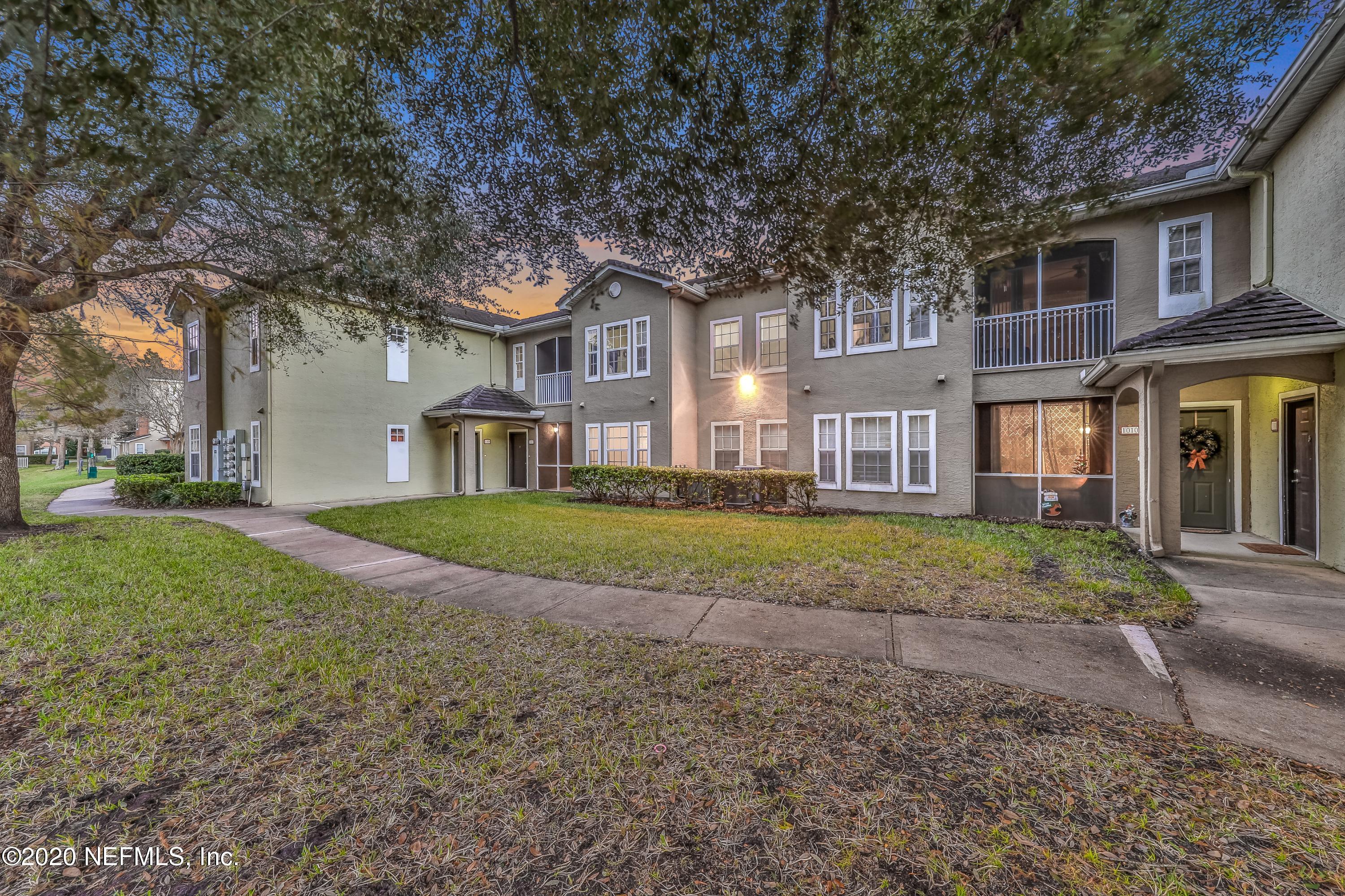 10075 Gate Parkway, Unit 1009 Jacksonville, FL 32246 - Photo 30 of 51 a view of a big house with a big yard and large trees