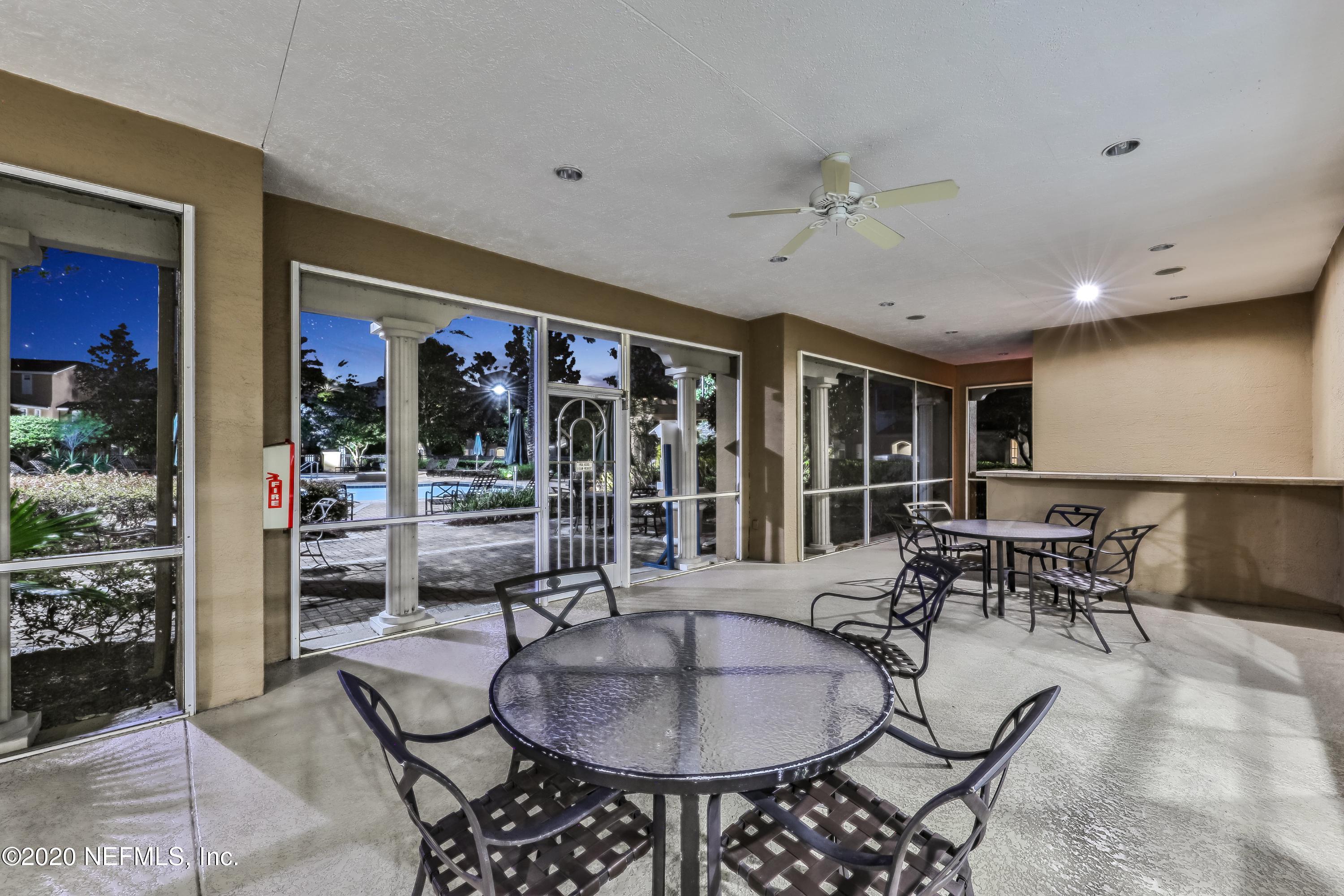 10075 Gate Parkway, Unit 1009 Jacksonville, FL 32246 - Photo 35 of 51 a dining room with furniture a rug and chandelier