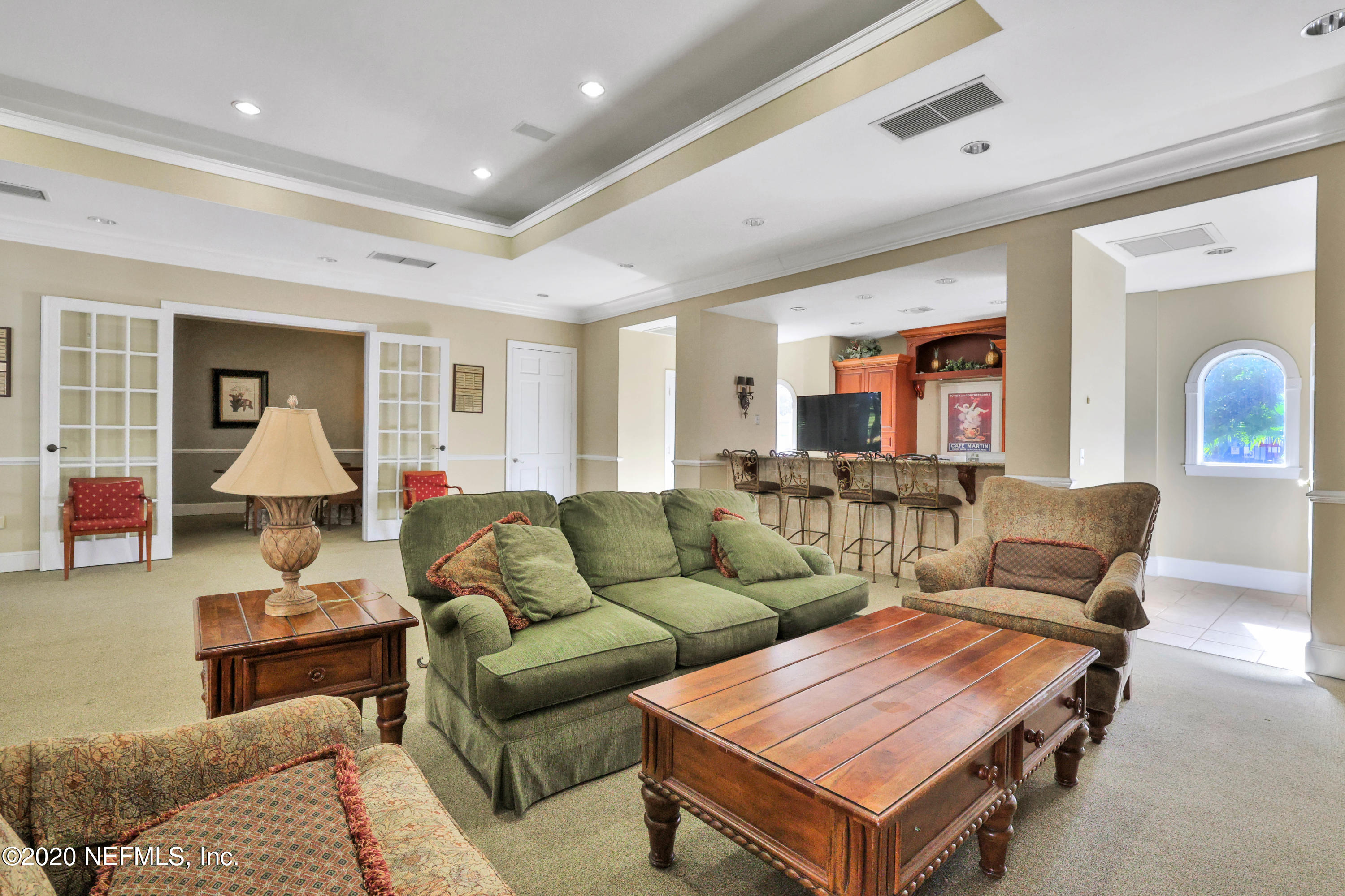 10075 Gate Parkway, Unit 1009 Jacksonville, FL 32246 - Photo 40 of 51 a living room with furniture a ceiling fan and a window