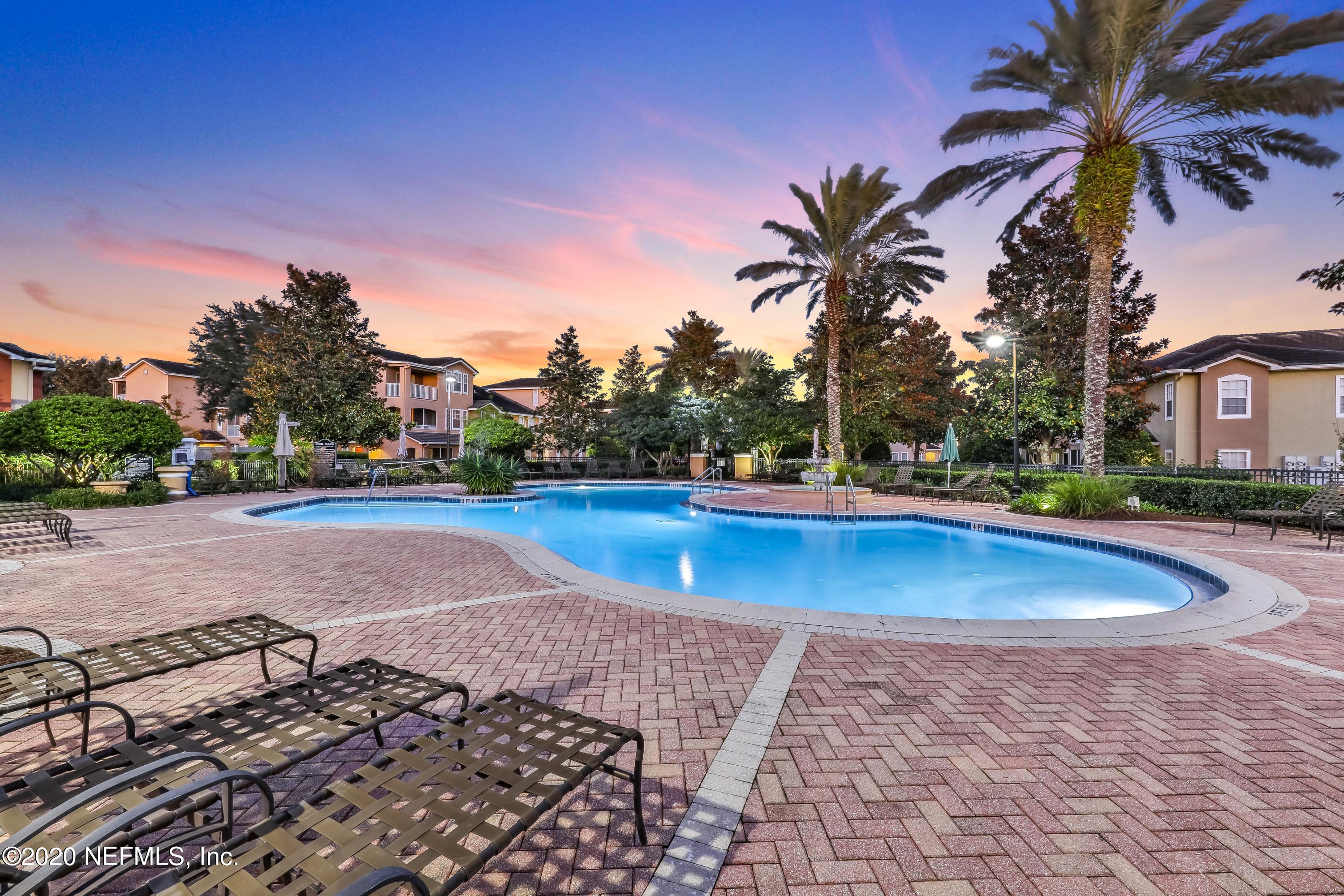 10075 Gate Parkway, Unit 1009 Jacksonville, FL 32246 - Photo 50 of 51 a view of yard with swimming pool and tall trees
