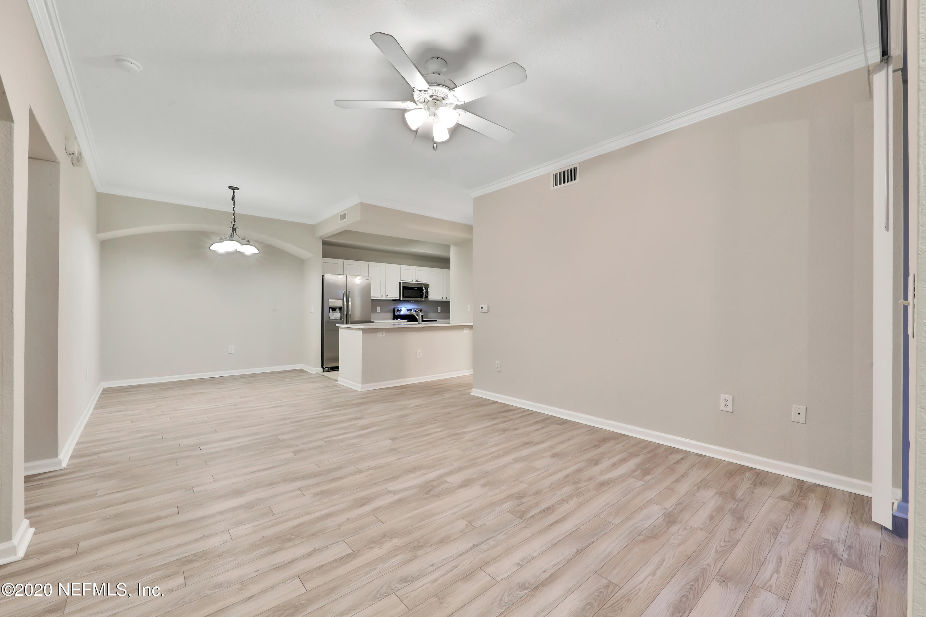 10075 Gate Parkway, Unit 1009 Jacksonville, FL 32246 - Photo 8 of 51 wooden floor in an empty room with a window
