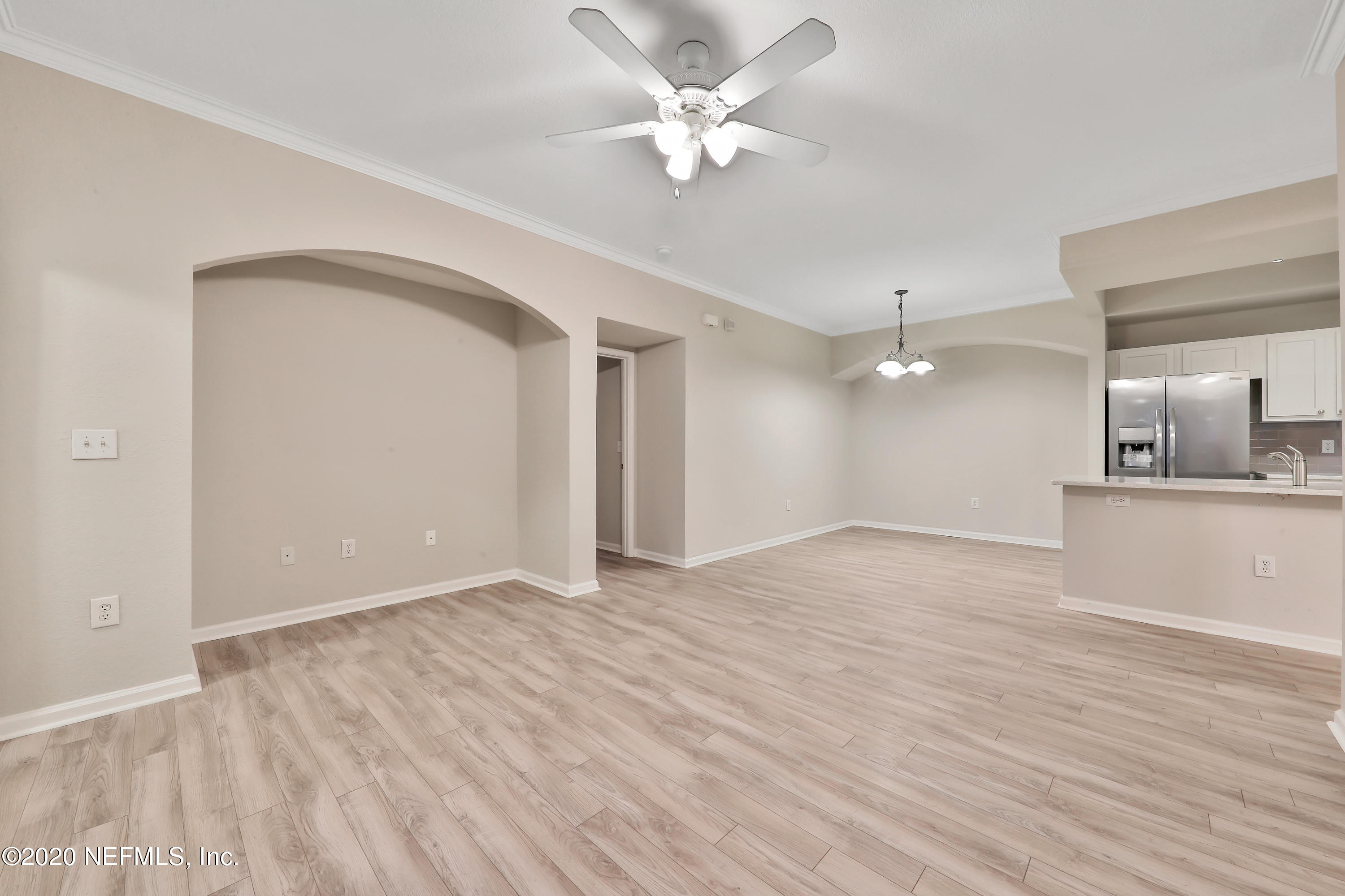10075 Gate Parkway, Unit 1009 Jacksonville, FL 32246 - Photo 9 of 51 wooden floor in an empty room with a window
