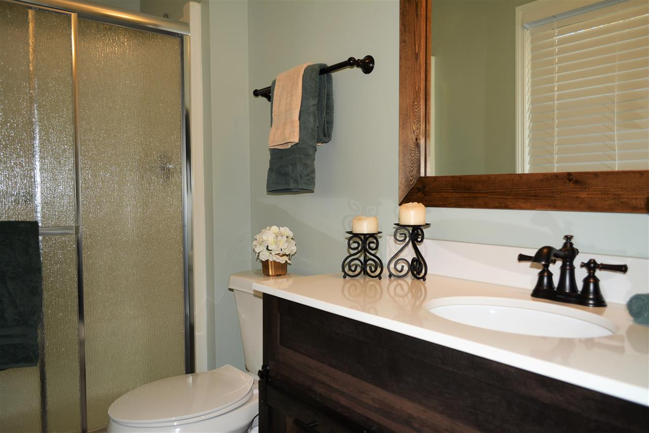 7249 Rock Service Station Road Raleigh, NC 27603 - Photo 15 of 25 New vanity, new mirror, new lighting, new flooring and paint, new toilet-wow! Luxury Master bathroom