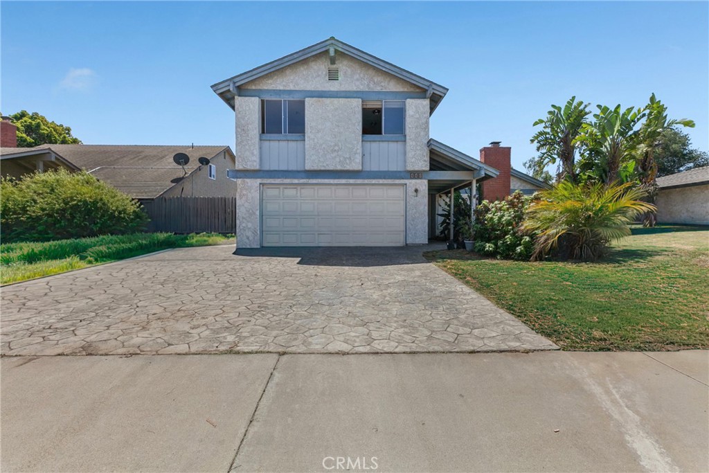440 Roble Street Santa Maria, CA 93454 - Photo 1 of 1 a house with a yard and a large parking space