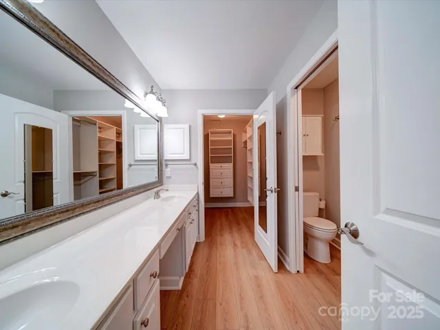 a bathroom with a double vanity sink and a large mirror