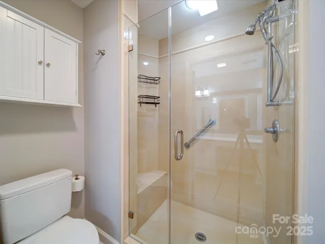 a bathroom with a shower a toilet and a sink