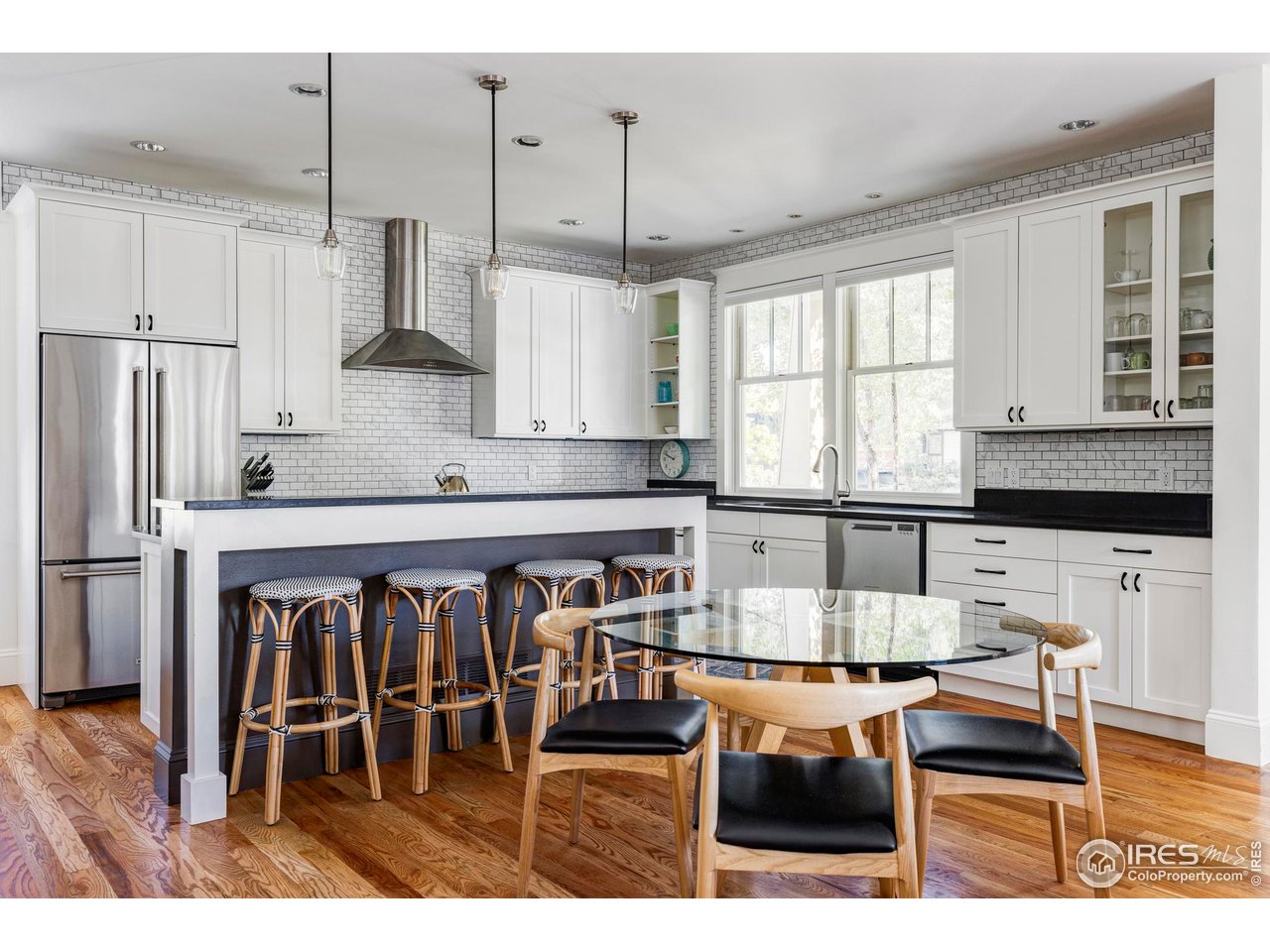 2129 23rd Street Boulder, CO 80302 - Photo 8 of 32 a kitchen with stainless steel appliances granite countertop a stove top oven a sink a dining table and chairs
