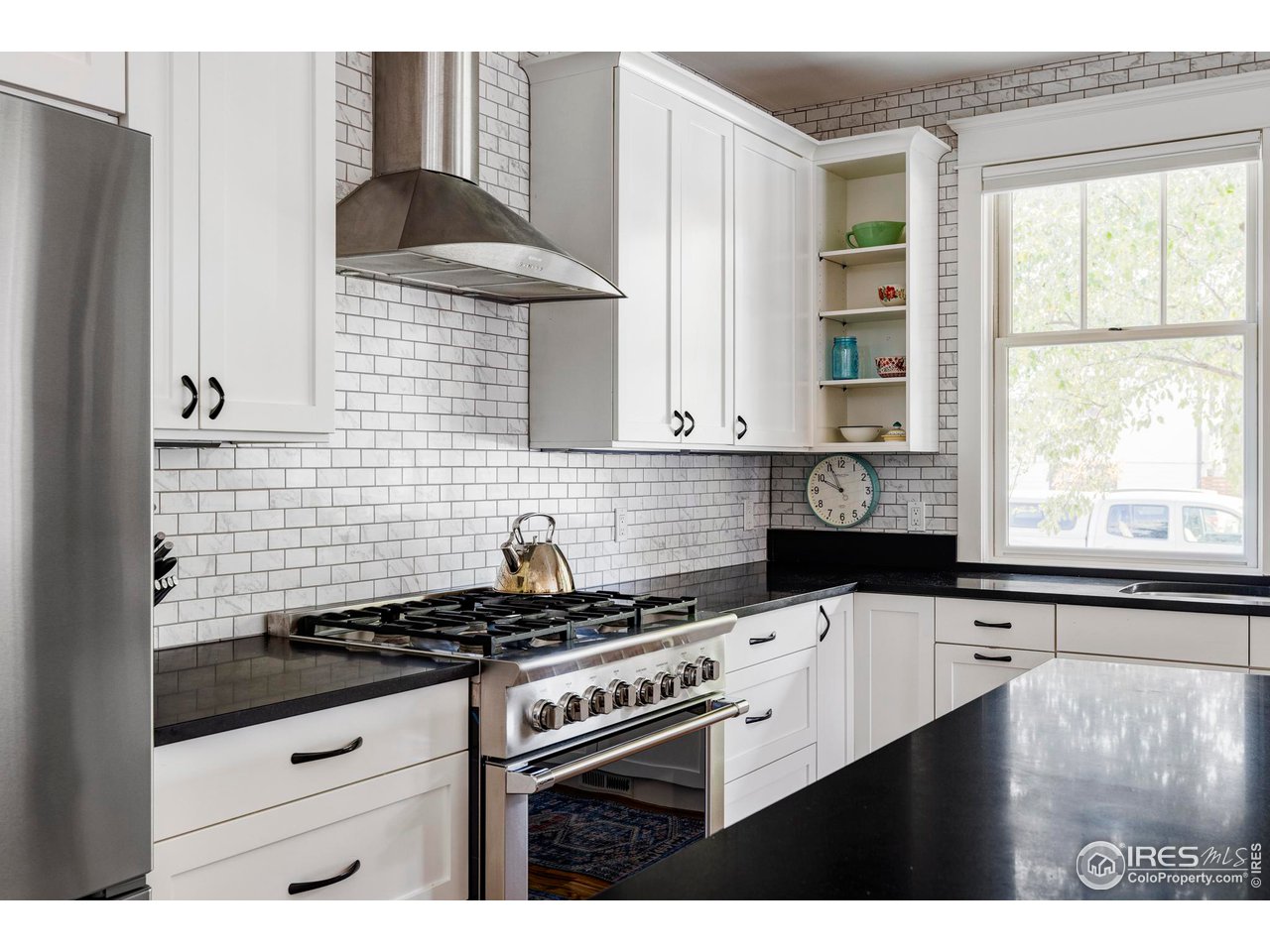 2129 23rd Street Boulder, CO 80302 - Photo 9 of 32 a kitchen with granite countertop a stove a sink a refrigerator and window