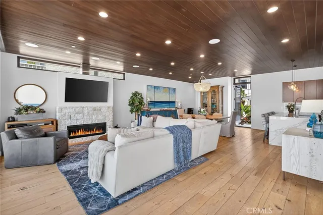 a living room with furniture a fireplace and a flat screen tv