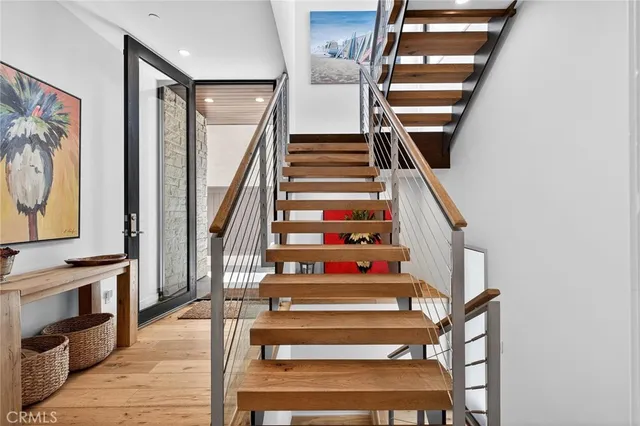 a view of entryway and hall with wooden floor