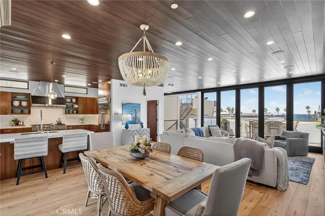 a view of a dining room with furniture a chandelier and wooden floor