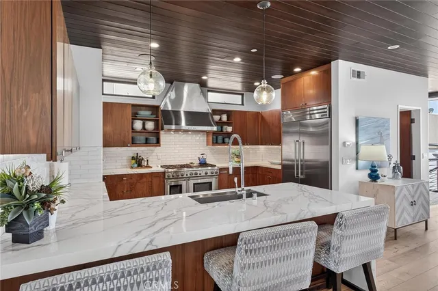 a kitchen with sink and refrigerator
