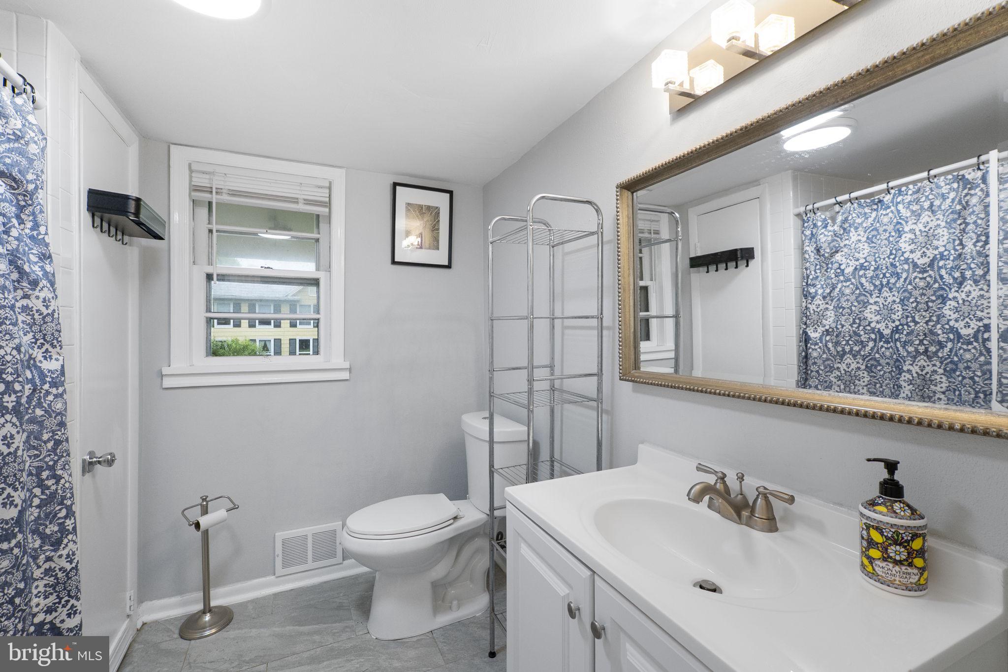 26001 Frederick Road Clarksburg, MD 20871 - Photo 14 of 46 a bathroom with a toilet sink and mirror