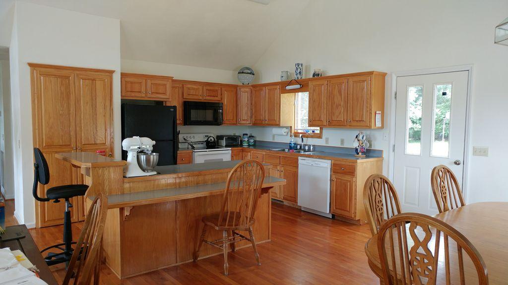2365 Dugspur Road Callaway, VA 24067 - Photo 14 of 55 a kitchen with granite countertop a stove top oven a sink a dining table and chairs