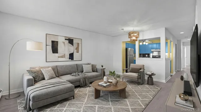 a view of a livingroom with furniture and a flat screen tv