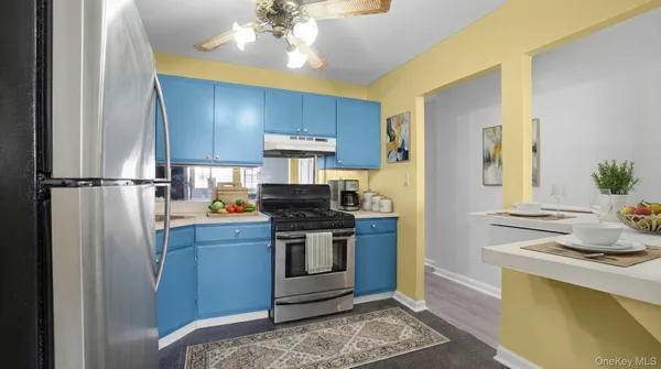 a kitchen with stainless steel appliances granite countertop a stove a refrigerator and a sink