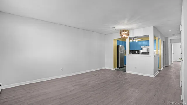 a view of a kitchen with a refrigerator a microwave and a sink
