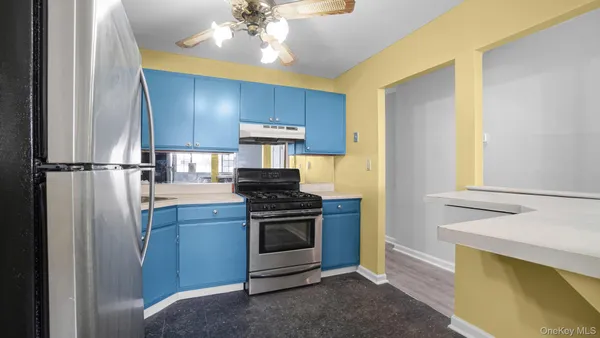 a kitchen with stainless steel appliances a stove a refrigerator and cabinets