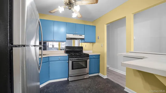 a kitchen with stainless steel appliances a stove a refrigerator and cabinets