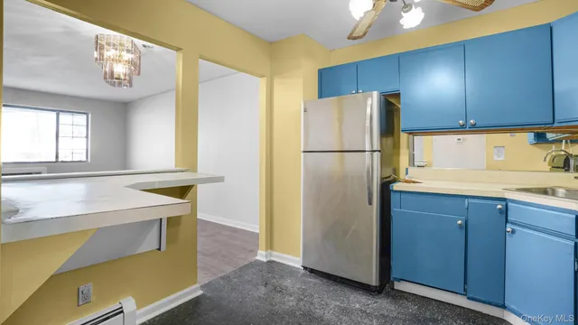 a kitchen with a refrigerator a sink and cabinets