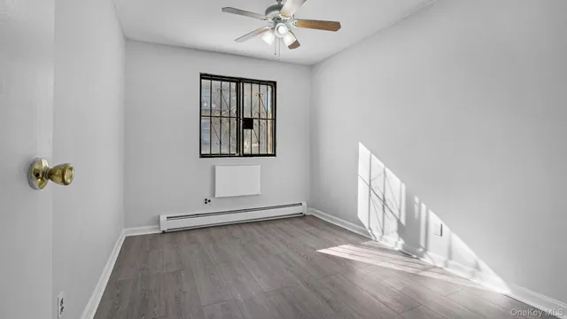 wooden floor in an empty room with a window