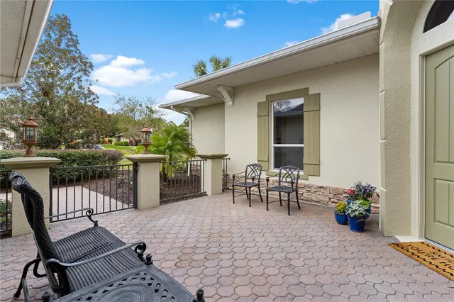 a kitchen with stainless steel appliances kitchen island granite countertop a stove top oven a sink a dining table and chairs with wooden floor