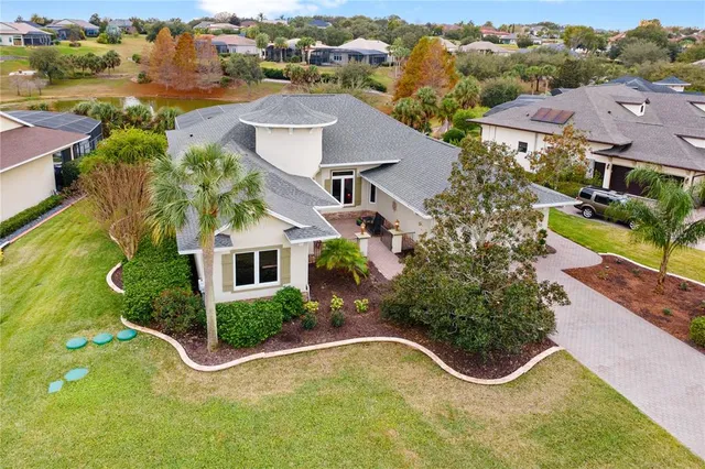 an aerial view of a house with a garden and swimming pool
