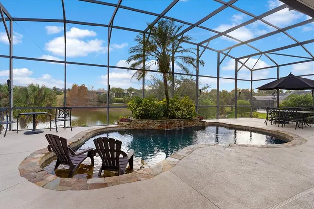 a view of a swimming pool with outdoor seating