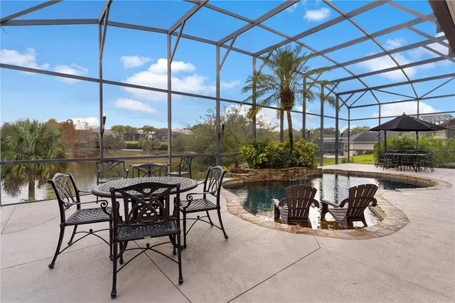 a view of a white house with a yard and potted plants