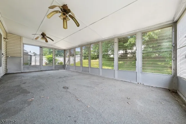 a view of an empty room with windows
