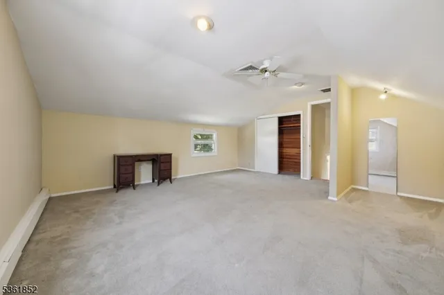 an empty room with fan and windows