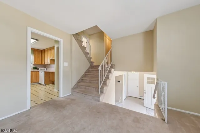 a view of a livingroom with wooden floor and entryway