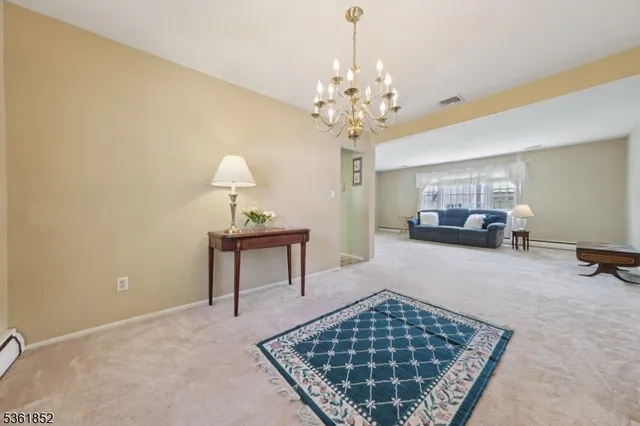 a living room with furniture and a chandelier