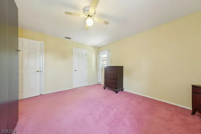 a view of an empty room with a fan