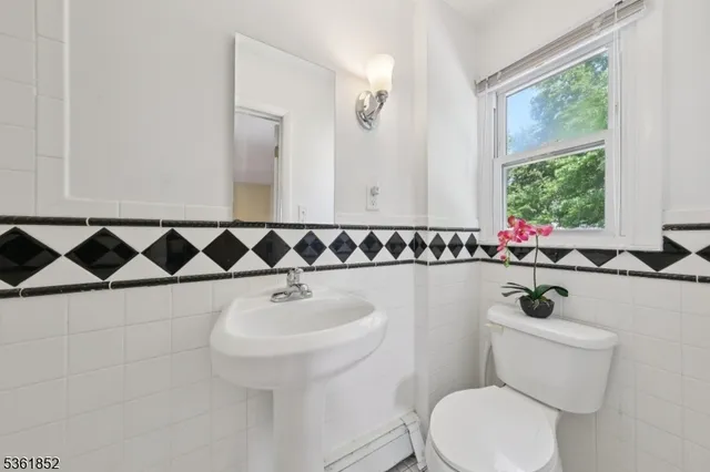 a bathroom with a sink mirror and toilet