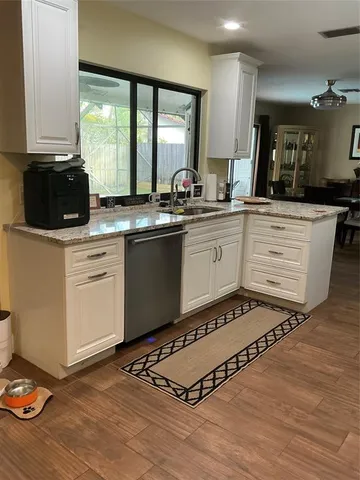 a kitchen with a sink stove and cabinets